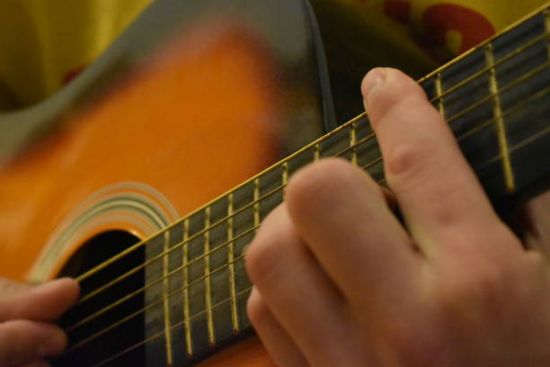 istock Caucasian male playing acoustic guitar 1487364116