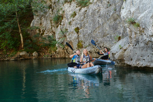 istock A group of friends enjoying having fun and kayaking while exploring the calm river, surrounding forest and large natural river canyons 1487365000