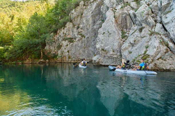 istock A group of friends enjoying having fun and kayaking while exploring the calm river, surrounding forest and large natural river canyons 1487366062