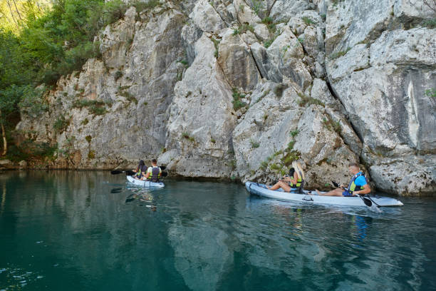 istock A group of friends enjoying having fun and kayaking while exploring the calm river, surrounding forest and large natural river canyons 1487366408