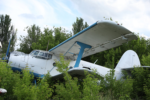 Old soviet aircraft biplane Antonov AN-2 parked on exhibition area in open air museum. Kharkiv, Ukraine - August 23. 2021