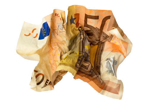 Crumpled and torn 50 Euro banknote on white background (Euro credit crisis)