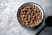 Fresh breakfast with chocolate balls with milk in a bowl