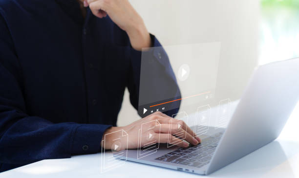 istock Man use computer for streaming online on virtual screen, watching video on the internet, live content, show or tutorial, content online, live concert, webinar, broadcast online, media show digital, 1487368719