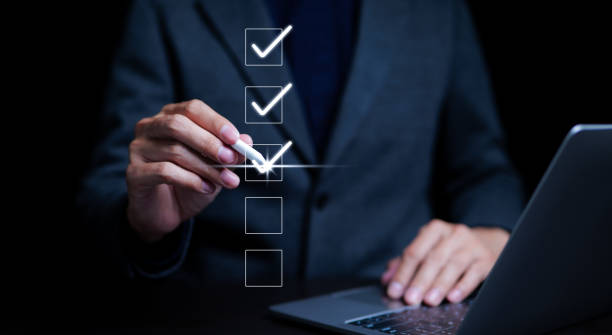 istock Businessman using laptop doing online checklist survey, filling out digital form checklist, take an assessment, business performance checklist, questionnaire, evaluation, online survey, online exam. 1487368739
