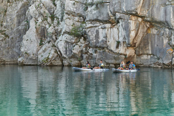 istock A group of friends enjoying having fun and kayaking while exploring the calm river, surrounding forest and large natural river canyons 1487369790