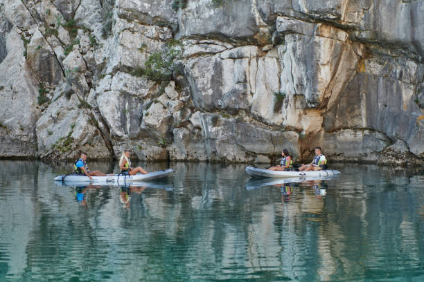 istock A group of friends enjoying having fun and kayaking while exploring the calm river, surrounding forest and large natural river canyons 1487369951