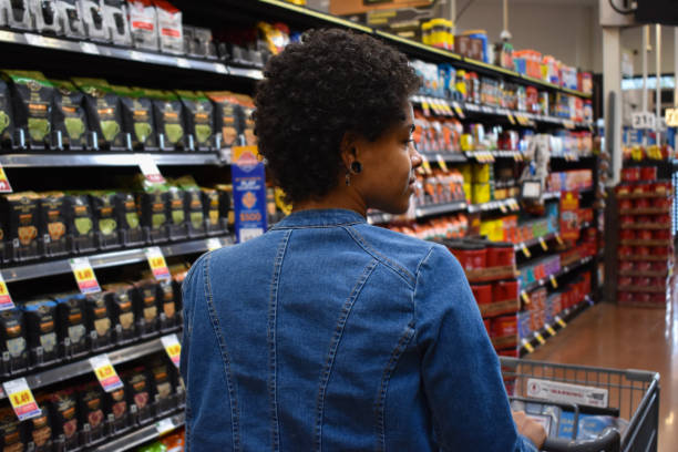 Grocery Shopping - Coffee Aisle - Pushing Cart stock photo