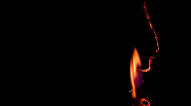 burning paper, glowing edge of paper on a black background
