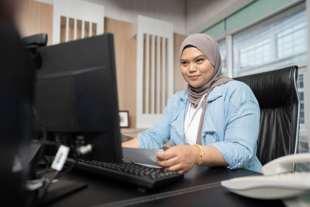 istock Working with coworker at office 1487374276