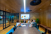 Diverse group of people meeting and working at a board room table at a business presentation or seminar