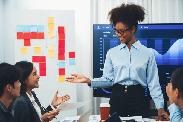 istock Young african businesswoman presenting data analysis dashboard on TV. Concord 1487382202