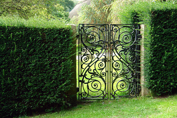 Black wrought iron garden gate stock photo