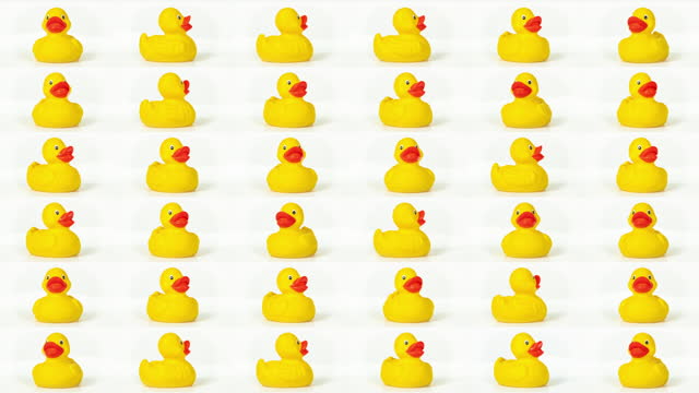 Rubber duck rotating against white background in a sequence