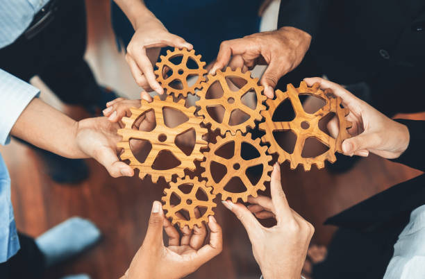 istock Office worker holding cog wheel as unity and teamwork in workplace. Concord 1487385262