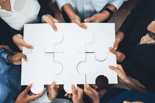 istock Diverse corporate officer workers connecting puzzle pieces. Concord 1487385351