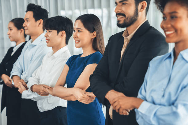 istock Multiracial office worker hold hand in a line promoting synergy. Concord 1487385395