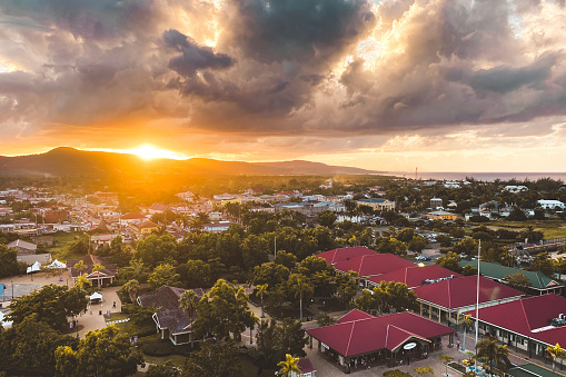 Sunset over Falmouth and cityscape of the town on the island of Jamaica against cloudy sky
