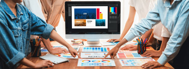 Graphic designer brainstorming logo and graphic arts at workshop. Scrutinize Graphic designer brainstorming logo and graphic art at busy artistic workshop, laptop display workspace. Experimenting color palette and pattern for creative design. Panorama shot. Scrutinize design professional stock pictures, royalty-free photos & images