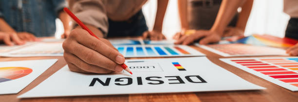 istock Graphic designer brainstorming logo and graphic arts at workshop. Scrutinize 1487386618