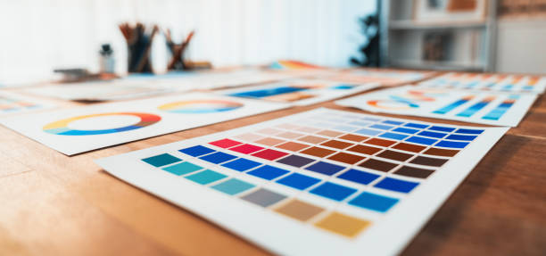 istock Various color palette idea papers arranged on workspace for designer. Scrutinize 1487387199