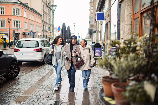 Close up of Three young women walking down a street in a town