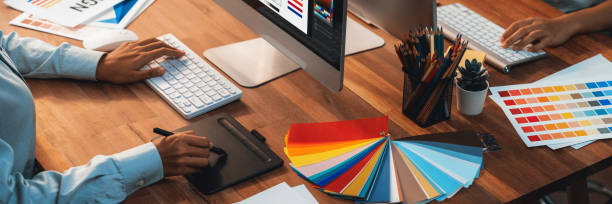 istock Graphic designer works on computer laptop with digital pen. Scrutinize 1487389306