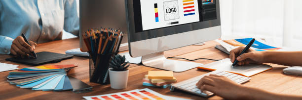 istock Graphic designer works on computer laptop with digital pen. Scrutinize 1487389360