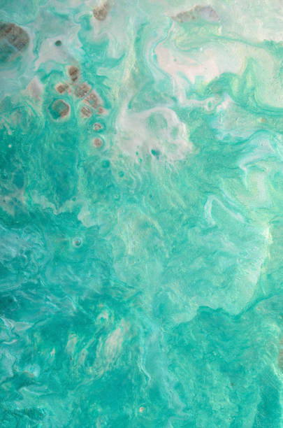 istock abstract background of emerald waves with white and pearl splashes 1487390325
