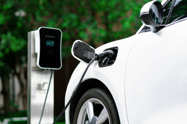 istock Focus closeup EV car and charger with blur background for progressive concept 1487397321