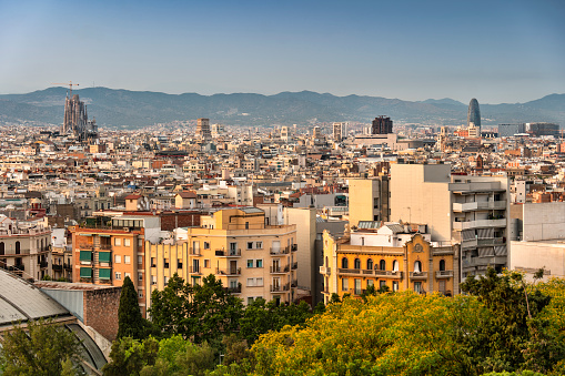 City skyline view of the many apartments, houses and buildings of downtown Barcelona Catalonia Spain as seen from atop Montjuic hill.