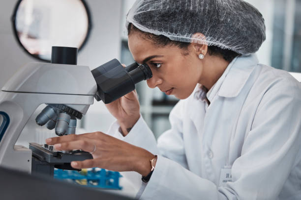 istock Scientist, black woman and microscope, analysis of data and science innovation, microbiology or biotechnology in lab. Work, scientific study and researcher, doctor and test with medical research 1487401565