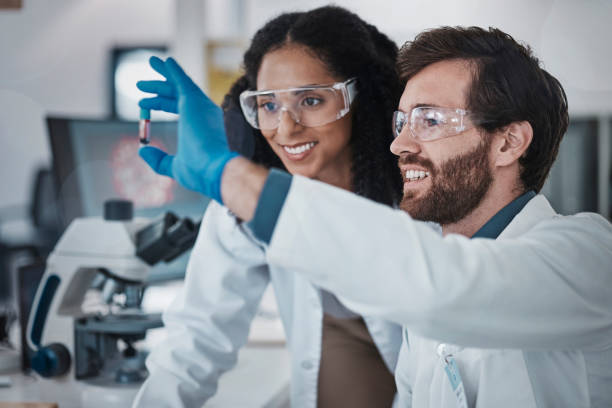 istock Teamwork, collaboration or blood test tube in laboratory research success, dna engineering innovation or medical vaccine. Smile, happy man or black woman with scientist sample for pharmacy medicine 1487401588