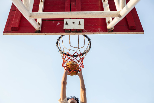Basketball Player Jumping up to dunk