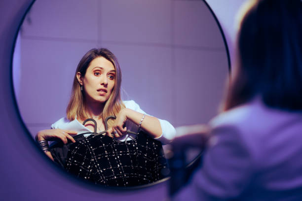 Woman Choosing Between Two Elegant Dresses for a Party