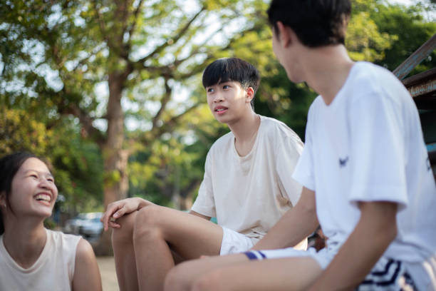 A group of three friends are sitting and talking.