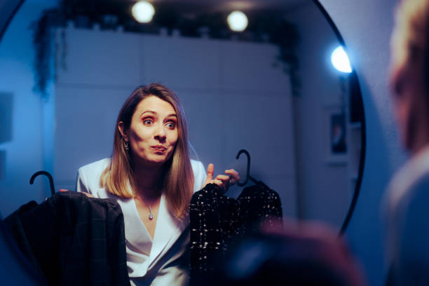 istock Woman Choosing Between Two Elegant Dresses for a Party 1487402664