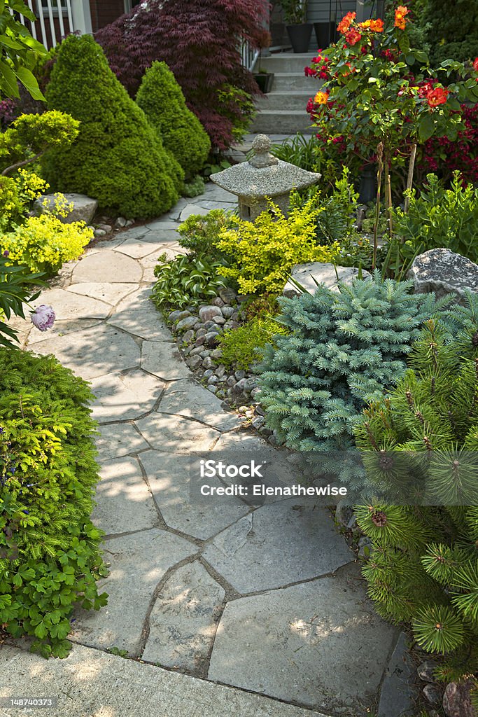 Garden path with stone landscaping Natural flagstone path landscaping in home garden Footpath Stock Photo
