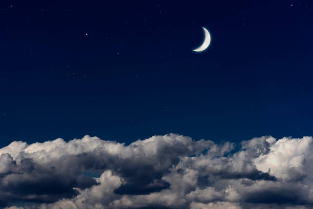 istock Crescent moon rising over the cloudscape 1487405153