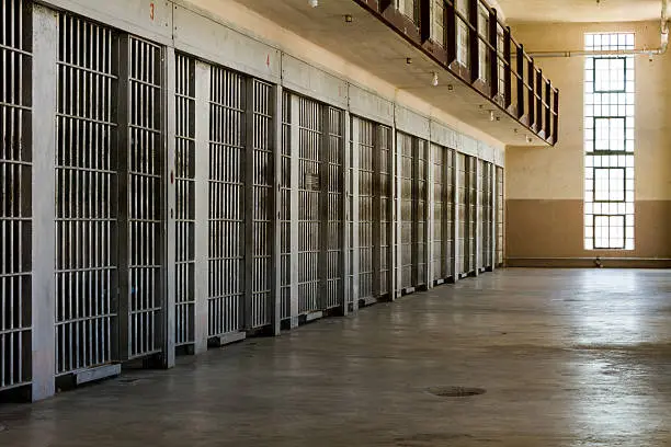 Photo of Jail cells lined up against the wall