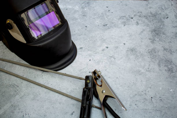 istock Welding mask, electrodes lie on a gray background 1487407314