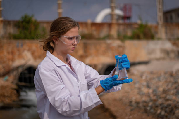 istock Scientist wearing protective uniform and glove under working water analysis and water quality by get waste water to check case in laboratory is environment pollution problem concept. 1487407841