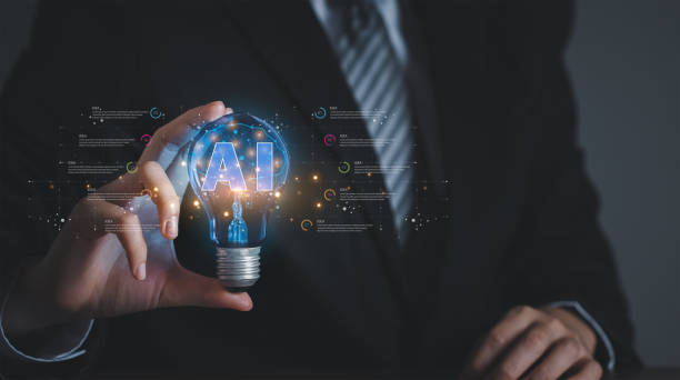 istock Concept of finding business ideas using artificial intelligence. Businessman hand holding light bulb that symbolizes idea. 1487408520