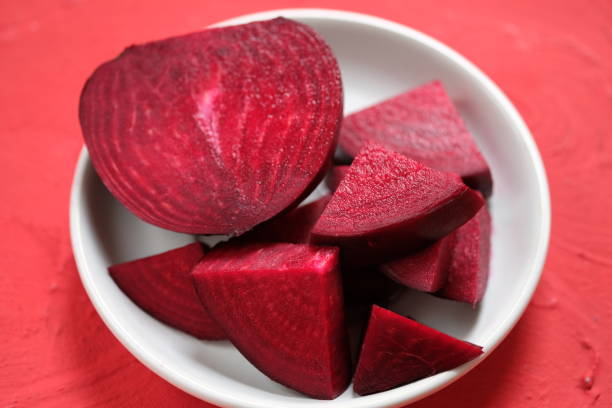 istock Beta vulgaris. sliced beetroot on a white plate on the red table. golden beet or red beet. red vegetables. 1487410870