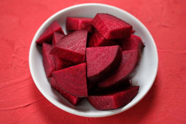 istock Beta vulgaris. sliced beetroot on a white plate on the red table. golden beet or red beet. red vegetables. 1487410892