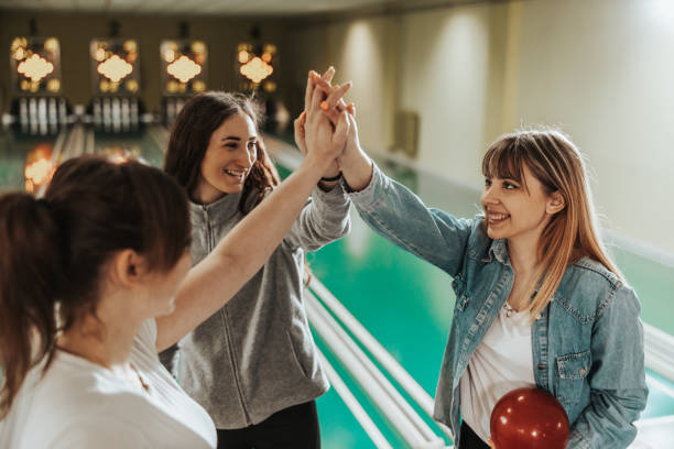 istock Three Female Bowling Players Having Fun And Celebrating The Win 1487412085