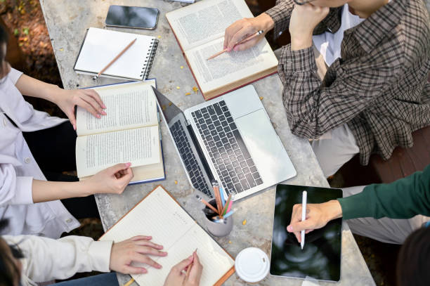 istock Top view of a group of college students doing homework, doing school project 1487413999