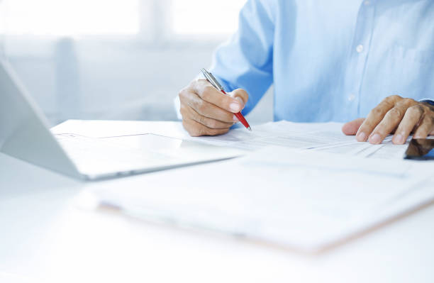 istock business person working on desk 1487417111