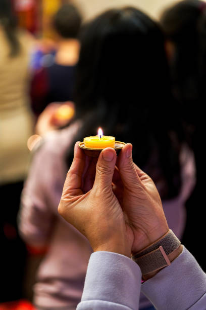istock People holding small candle holders in the blessing 1487417415