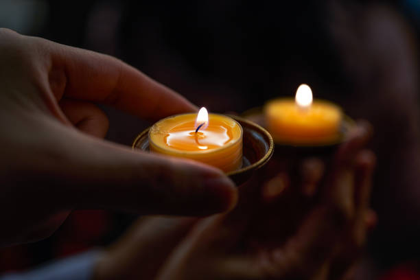 istock People holding small candle holders in the blessing 1487417425